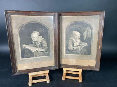 two framed pictures of a man reading a book and a woman reading a book