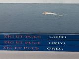 a stack of blue books sitting on a white table