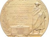 an image of a gold medal with a man in a hat on it