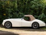 a white sports car parked on the side of the road