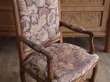 a chair with a floral upholstered seat in a room