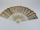 an old fan is sitting on a table with a white background