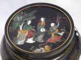 a black and gold box with a painting on it
