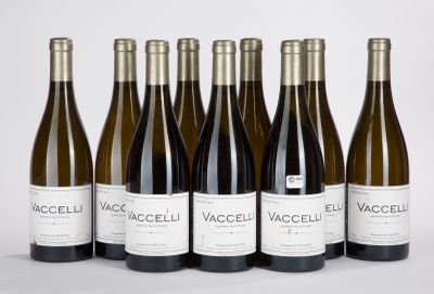 six bottles of wine are lined up in a row on a white surface