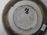a close up of a bowl with a number on it