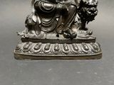 a statue of a man sitting on top of a table