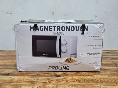 packaging of a white microwave sitting on top of a wooden table