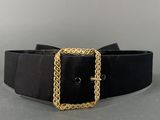 the belt is black and has a gold chain on it