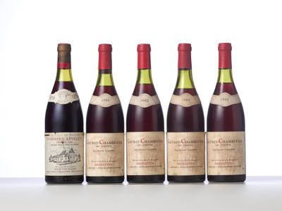 four bottles of wine are lined up on a table