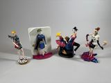 four figurines of different types of people on a table