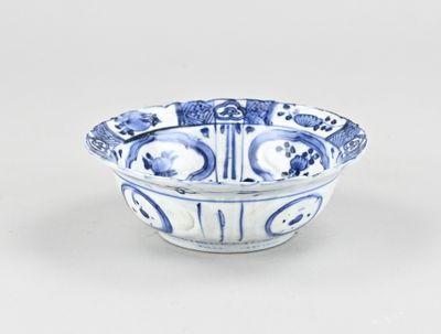 blue and white bowl with a design of flowers and birds