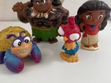 four disney figurines of different characters on a white surface