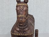 a small wooden horse with a saddle on it ' s back