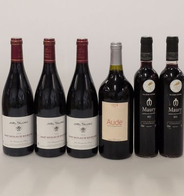 several bottles of wine are lined up in a row on a table