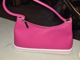 pink purse sitting on a table next to a pair of shoes