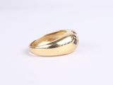 a close up of a gold ring on a white surface