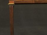 an antique wooden desk with two drawers and a brass plate on top