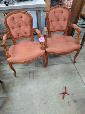 two chairs sitting next to each other on the floor