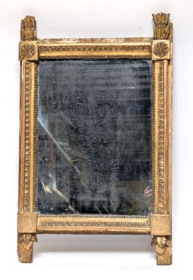 an image of a gold framed mirror sitting on top of a white wall