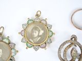 three antique photo frames are displayed on a white surface