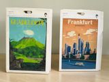 two boxes that have a picture of a city on them