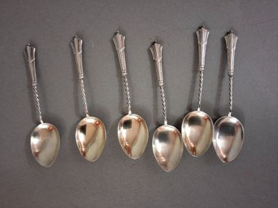 six spoons are lined up in a row on a table