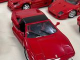 a lot of red toy cars that are on a table