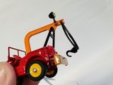 a hand holding a red toy truck with a crane on top of it