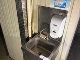 a sink and a toilet in a public restroom