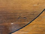 a close up of a wooden table with a knife on it