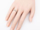 an image of a woman ' s hand with a diamond ring on it