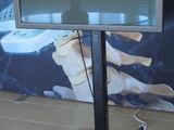 a flat screen tv sitting on a stand in a room