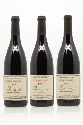 trois bouteilles de vin rouge sont alignées sur une surface blanche