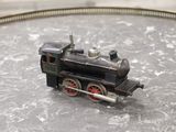 a small toy train on a table with a train track