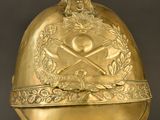 an antique gold helmet with a skull and crossbones on it