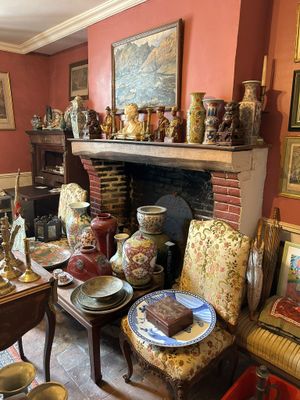 un salon avec une cheminée et de nombreux vases