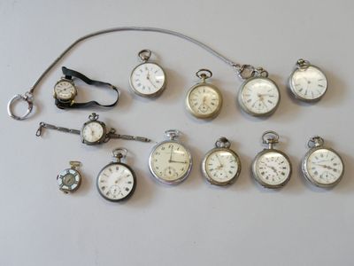 many different types of pocket watches displayed on the table