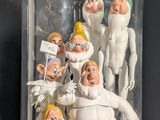 figurines of a group of people under a glass dome on a table