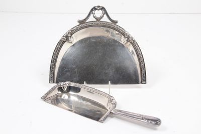 a silver mirror and a silver spoon on a white surface