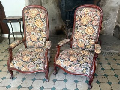 two chairs sitting next to each other on a tiled floor