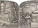 an image of a silver medal with a train on it