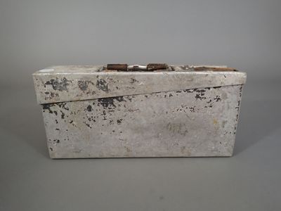 a white box with a handle on a gray surface