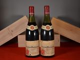 two bottles of wine sitting on top of a table next to a wooden box