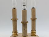 brass table lamp with three candles on a round base