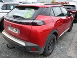 a red car parked in a parking lot with other cars
