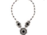 a close up of a necklace on a white background
