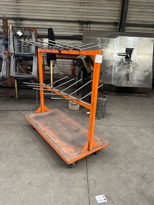 an orange shelf with a bunch of clothes hanging on it