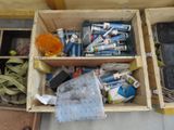 a wooden box filled with assorted items on the floor