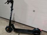a scooter that is parked in front of a garage door