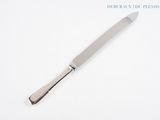 a knife that is laying on a white surface
